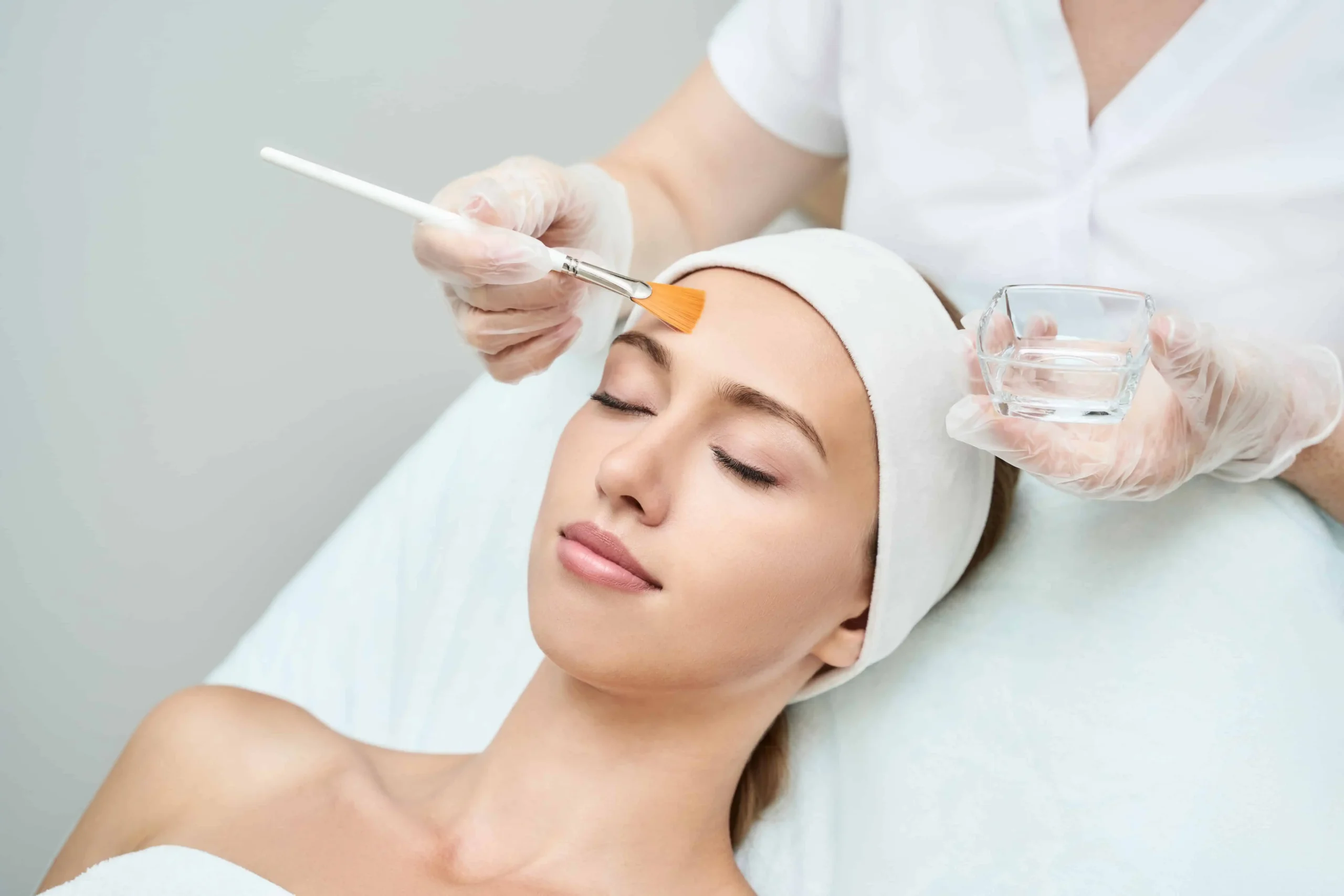 Doctor applying peel with brush on patient face | Modern Looks Med Spa | Georgia